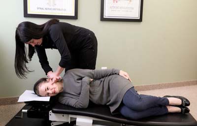 Chiropractor Troy MI Jamie Cramer Patient Getting Adjustment